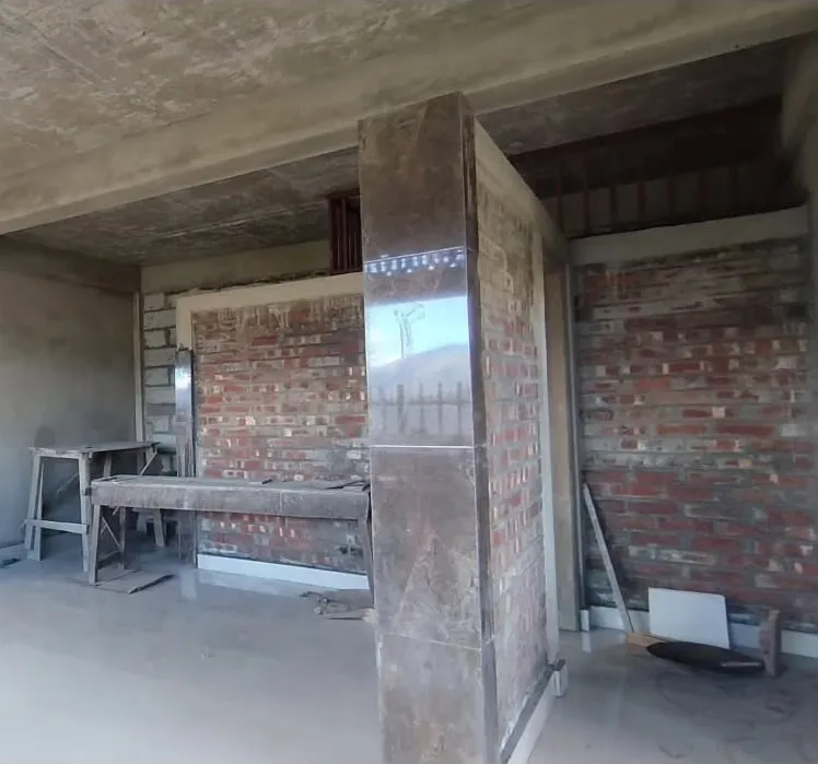 The same room as a bare concrete shell before work began